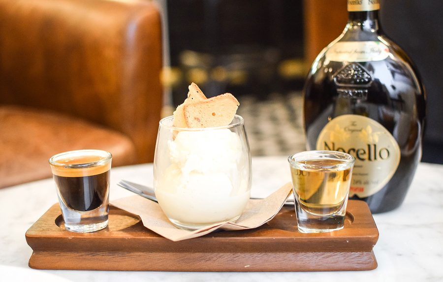 Affogato with a shot of coffee and liqueur on a wooden tray