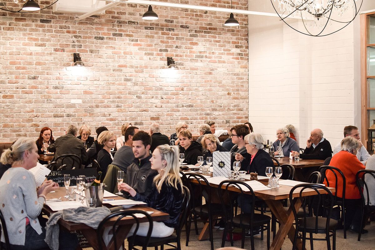 The dining room full of guests at timber tables