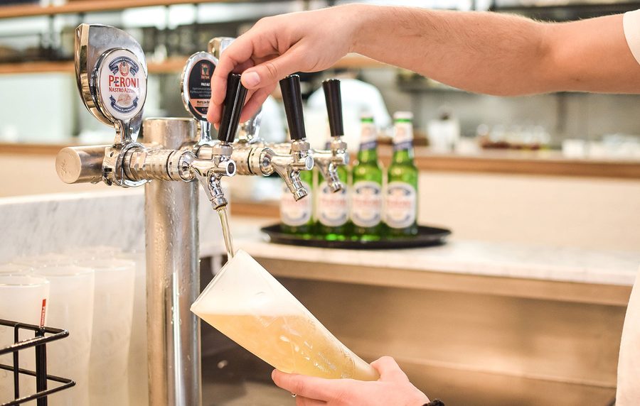A beer being poured from the taps behind the bar
